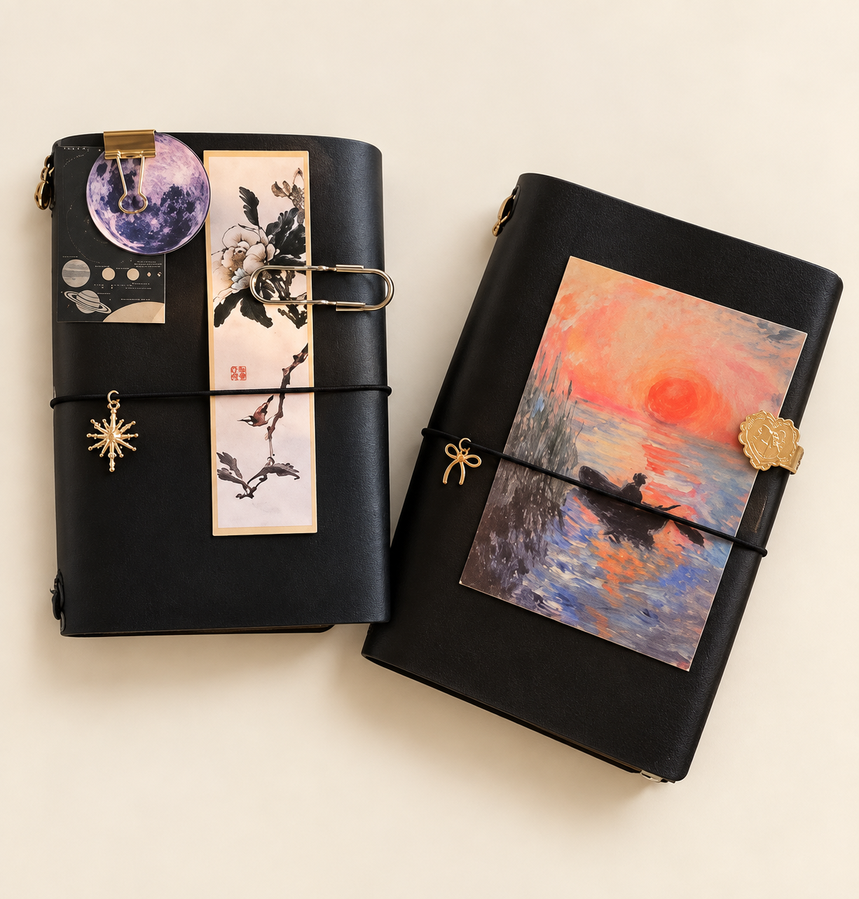 Two decorated dark leather journals on a clean ivory surface, with celestial, botanical and sunset artwork