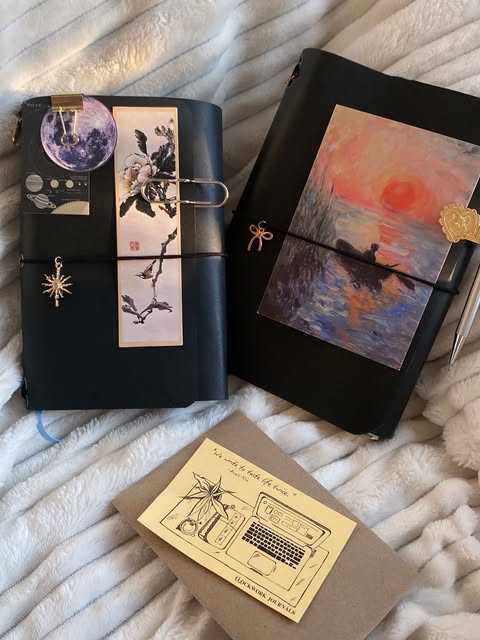 Dark journals with a moon collage and a sunset painting
